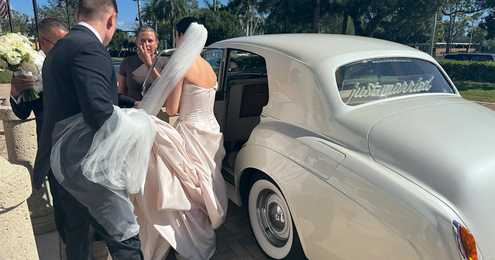 Gabby and Stephen Wedding Saint William Catholic Church Naples Florida November 2025 Bride Gabby arriving in a vintage cream white Rolls-Royce Silver Cloud II with a Just Married sign on the rear window at Saint William Catholic Church in Naples Florida