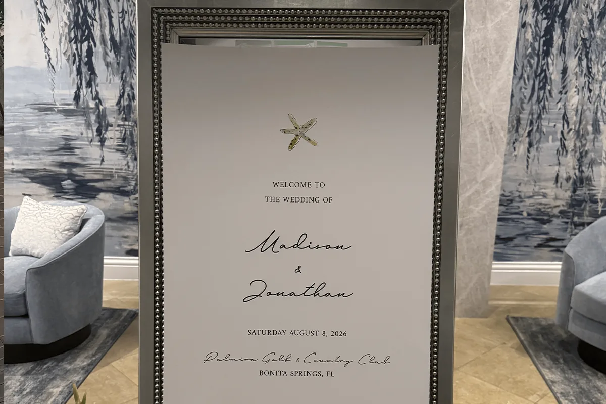Wedding Welcome Sign Palmira Golf and Country Club Bonita Springs FL Framed wedding welcome sign with a starfish detail in the lobby of Palmira Golf and Country Club in Bonita Springs Florida