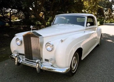 1960 Rolls-Royce Silver Cloud II in cream-white parked under trees, classic vintage wedding car