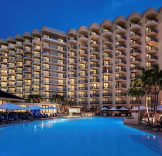 Hilton Marco Island Beach Resort and Spa wedding venue — beachfront resort with illuminated pool deck and Gulf of Mexico views on Marco Island, Florida