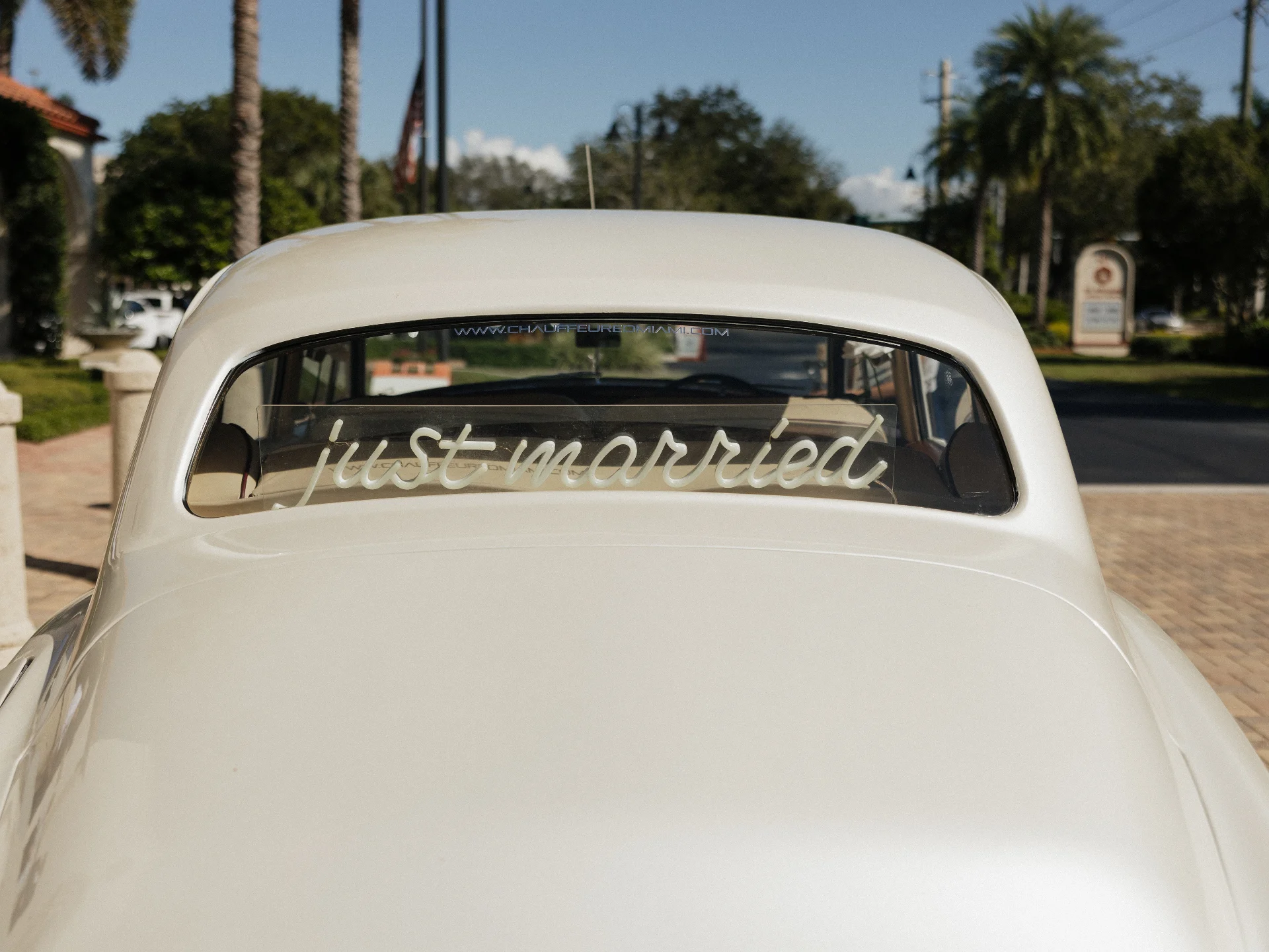 Rear view of vintage Rolls-Royce Silver Cloud with just married sign at Naples Florida wedding transportation