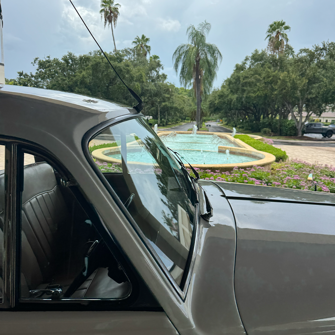 View of the Vineyards Country Club fountain and gardens through the window of a vintage Rolls Royce Silver Cloud II in Naples, Florida