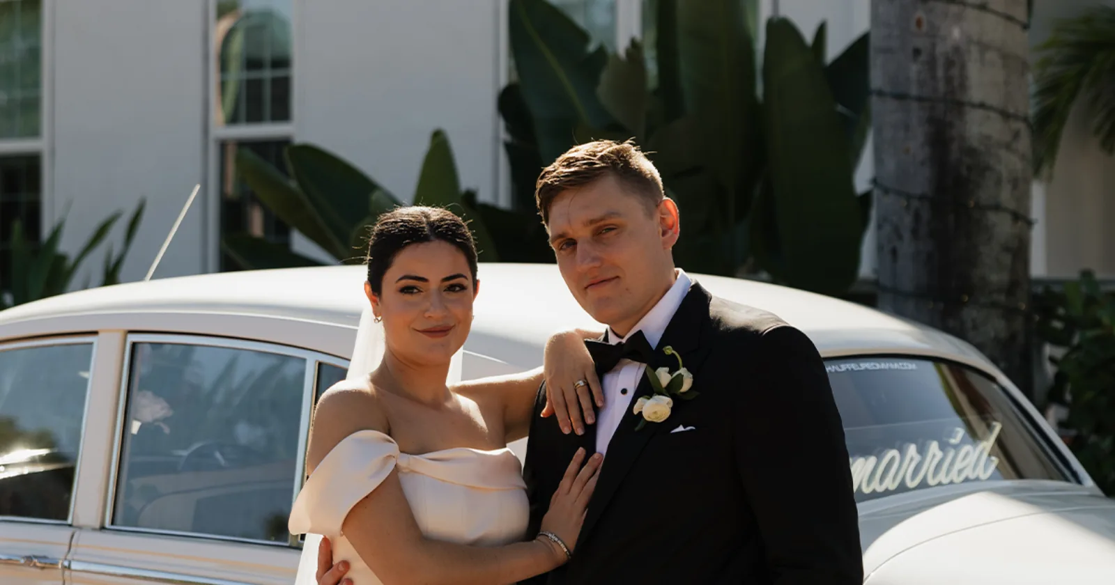 Gabby and Stephen Wedding Portraits Rolls-Royce Shangri-La Springs Bonita FL Bride Gabby and groom Stephen posing for wedding portraits in front of a vintage cream white 1960 Rolls-Royce Silver Cloud II at Shangri-La Springs in Bonita Springs Florida
