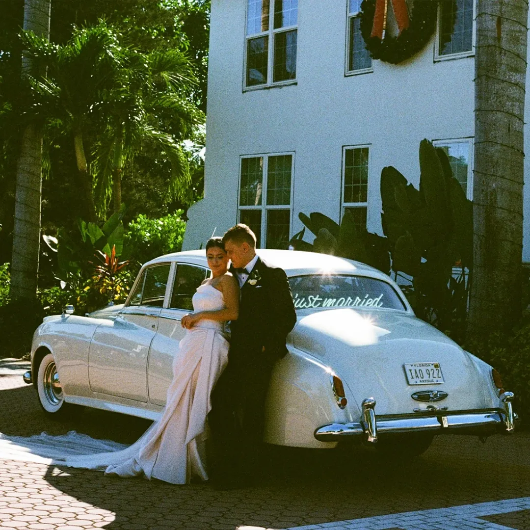 How Naples Wedding Car Got Started Rolls Royce Silver Cloud II Naples Florida Bride and groom beside a vintage cream white 1960 Rolls Royce Silver Cloud II at Shangri La Springs in Bonita Springs Florida