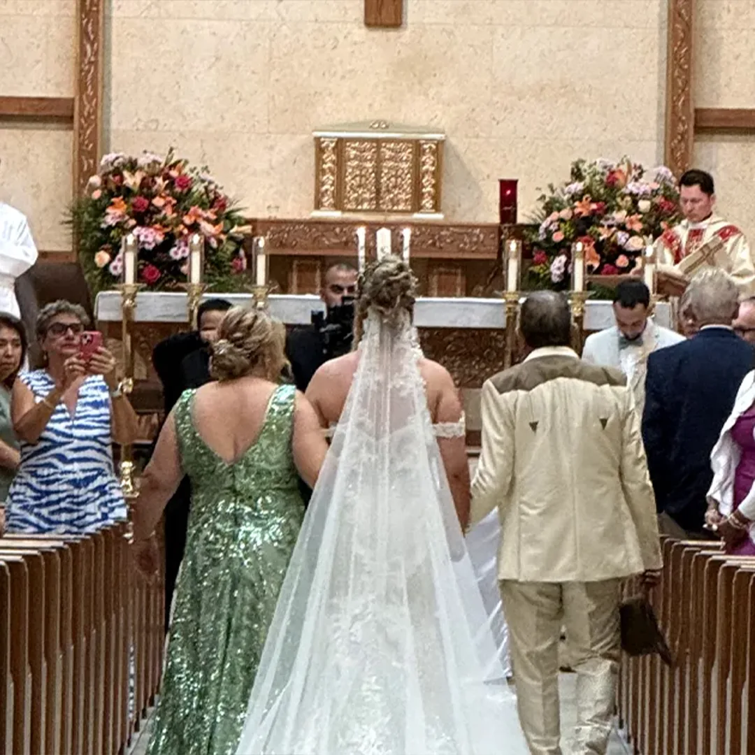Bride walking down the aisle at St Leo the Great Catholic Church during the Morelli wedding ceremony in Bonita Springs Florida