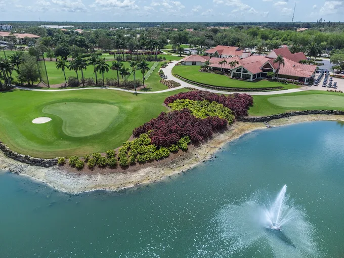 Countryside Golf & Country Club wedding venue — aerial view of the championship golf course, turquoise lake with fountain, and terracotta-roofed clubhouse in Naples, Florida