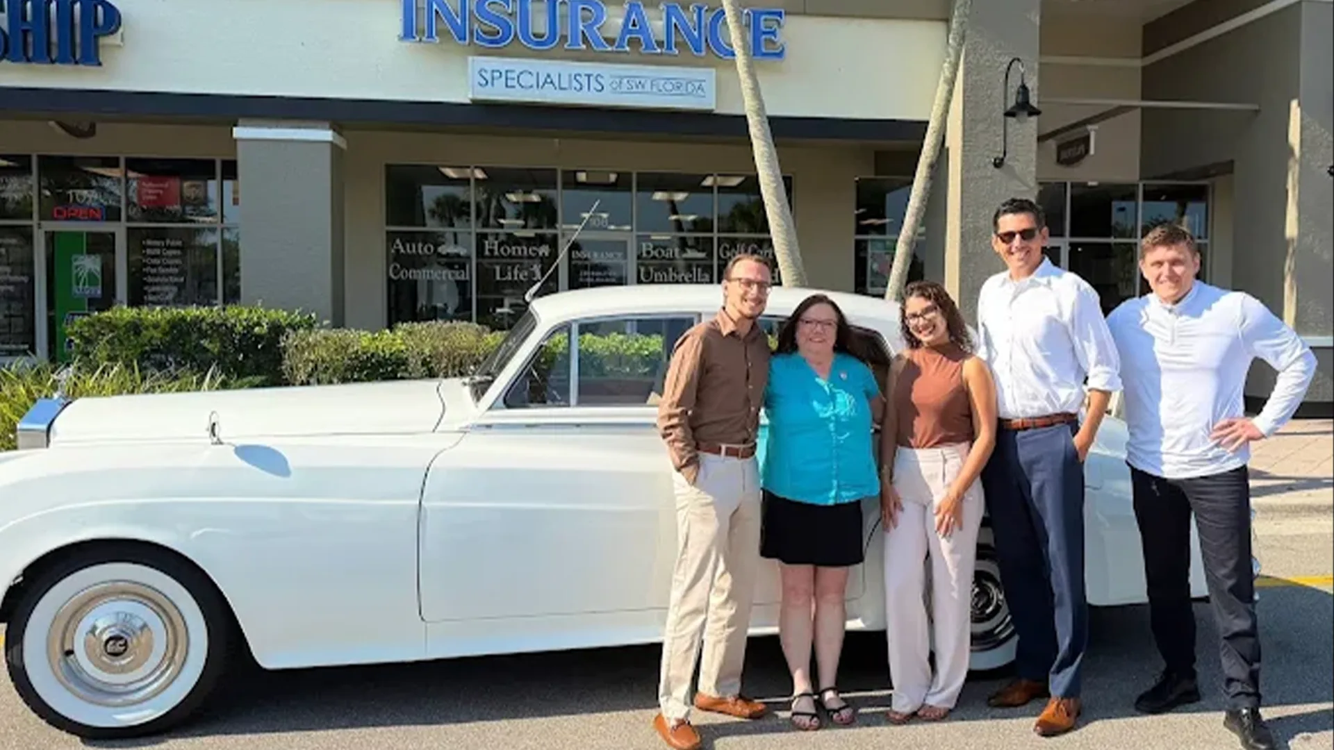 Insurance Specialists of SW Florida Team with the Rolls Royce Wedding Car The Insurance Specialists of SW Florida team standing with the vintage white Rolls Royce Silver Cloud II wedding car