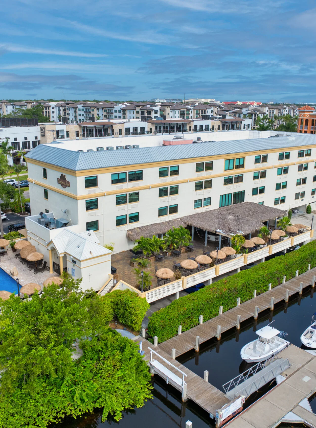 Bayfront Inn Naples aerial view of the waterfront hotel, tropical terrace and marina, a wedding venue in Naples, Florida