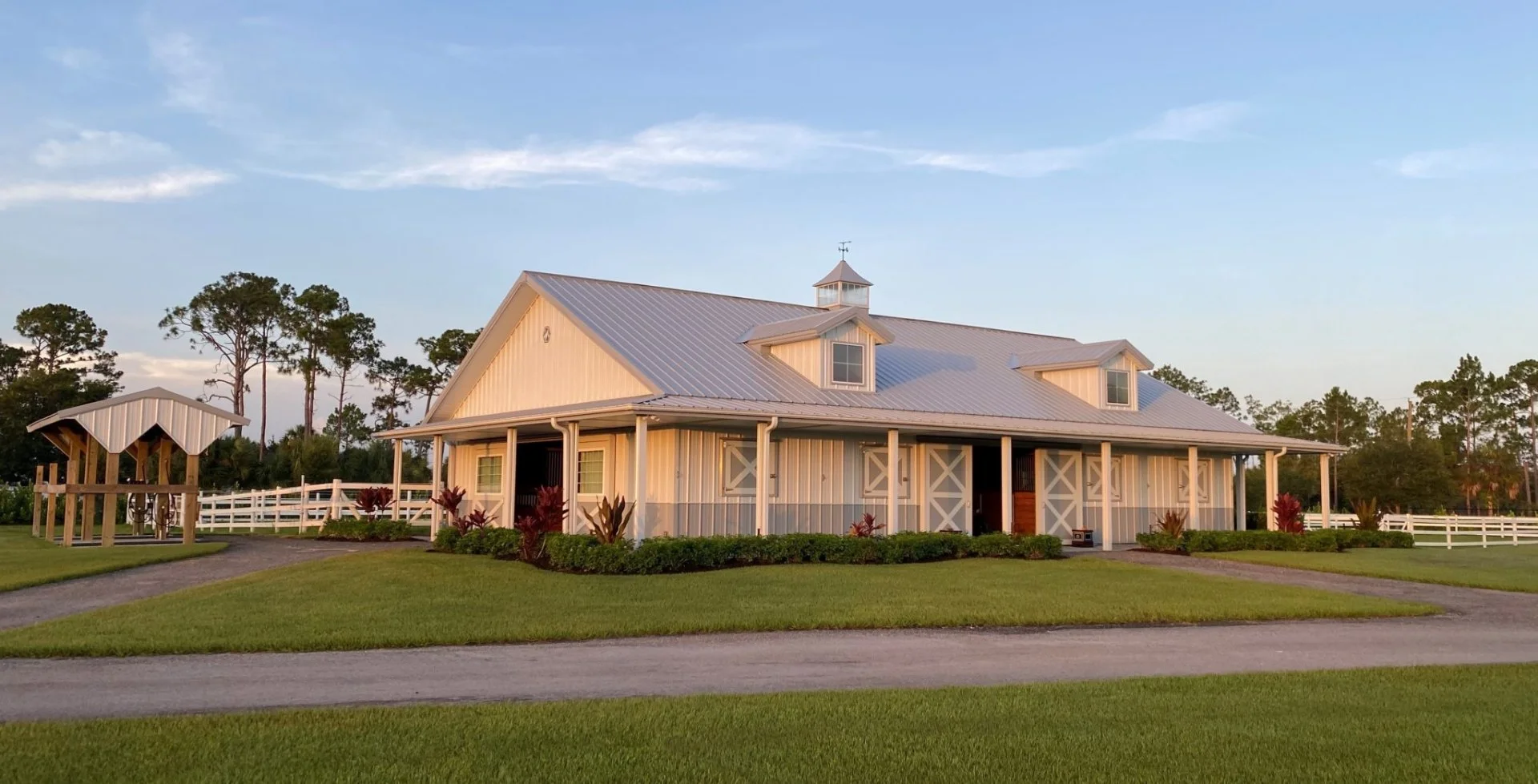 Shore Acres Farm wedding venue — white equestrian barn at golden hour in Naples, Florida