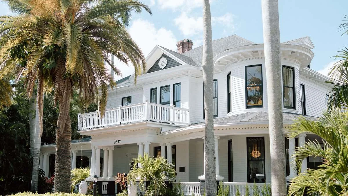 Heitman House wedding venue — historic white Victorian estate framed by royal palms in Ft. Myers, Florida