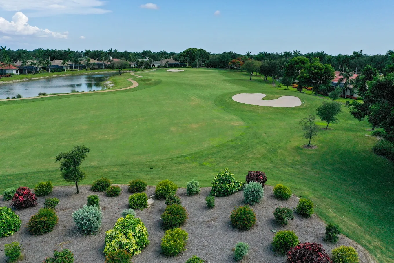 Palmira Golf Club Wedding Venue — Bonita Springs, FL Palmira Golf Club wedding venue — aerial view of the manicured fairway, lake, and tropical gardens in Bonita Springs, Florida