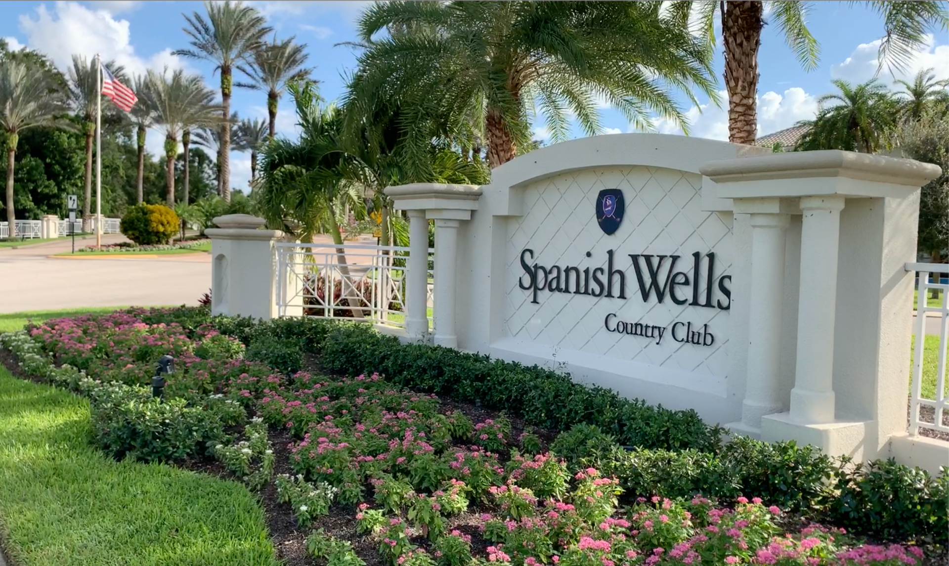 Spanish Wells Country Club Wedding Venue — Bonita Springs, FL Spanish Wells Country Club wedding venue — elegant stone entrance sign with palm trees and tropical gardens in Bonita Springs, Florida
