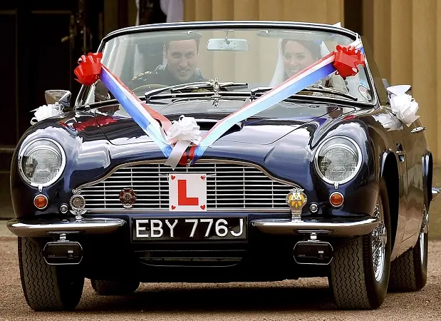 Prince William Kate Middleton Aston Martin DB6 Volante Wedding Car Prince William and Catherine Middleton in the 1969 Aston Martin DB6 Volante with red white and blue wedding ribbons