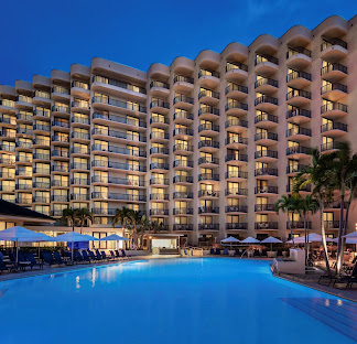 Hilton Marco Island Beach Resort and Spa Wedding Venue — Marco Island, FL Hilton Marco Island Beach Resort and Spa wedding venue — beachfront resort with illuminated pool deck and Gulf of Mexico views on Marco Island, Florida