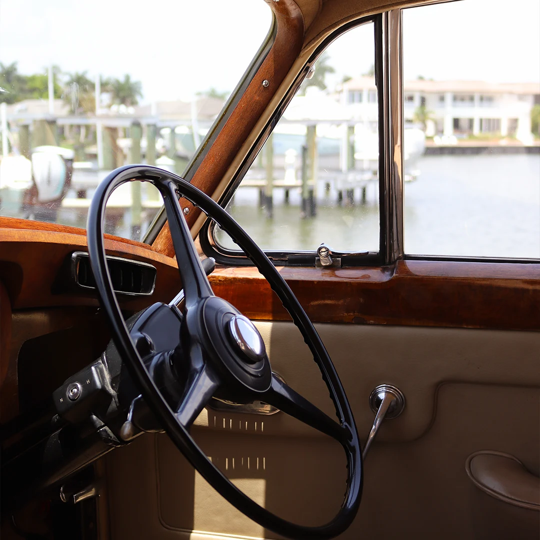 Interior wood dashboard and steering wheel of the vintage 1960 Rolls Royce Silver Cloud II overlooking Naples Bay, Florida