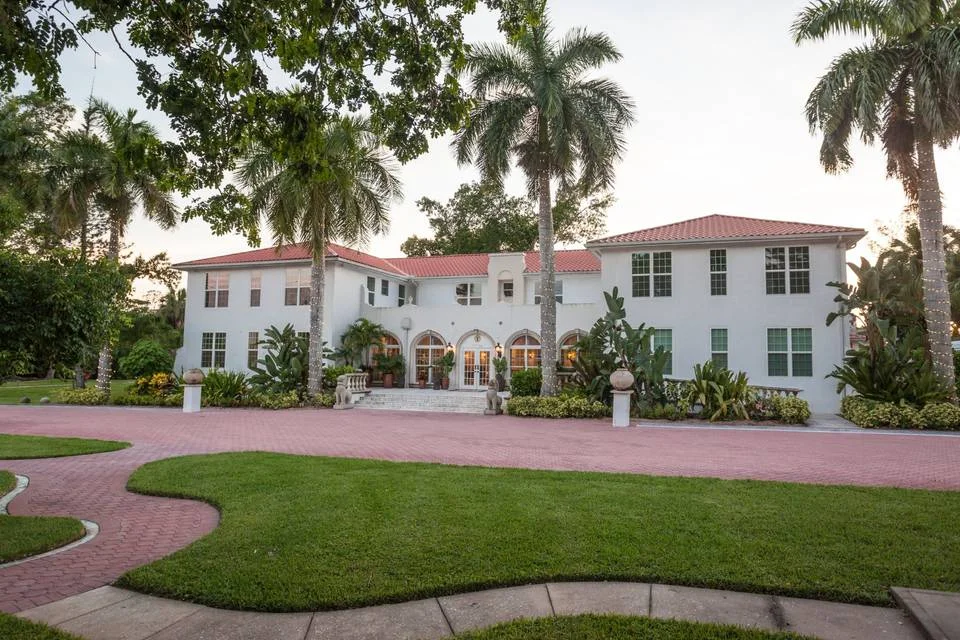 Shangri-La Springs wedding venue — historic white estate framed by royal palms in Bonita Springs, Florida