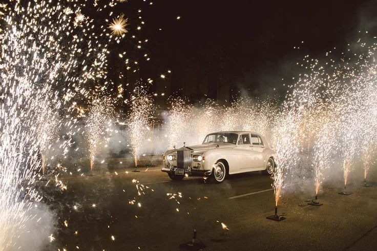 Naples Wedding Grand Exit with Rolls Royce and Sparklers Vintage white Rolls Royce Silver Cloud II surrounded by sparklers during a Naples wedding grand exit