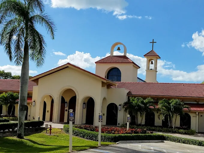 Saint Leo Catholic Church Wedding Venue — Bonita Springs, FL Saint Leo Catholic Church wedding venue — Mediterranean-style sanctuary with bell tower, cross, and arched colonnade framed by palms in Bonita Springs, Florida