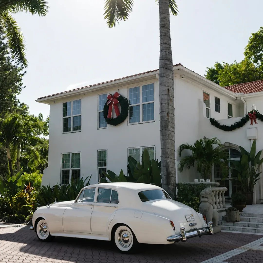 Rear three quarter view of a vintage cream white Rolls Royce Silver Cloud II at the historic Shangri-La Springs inn in Bonita Springs, Florida