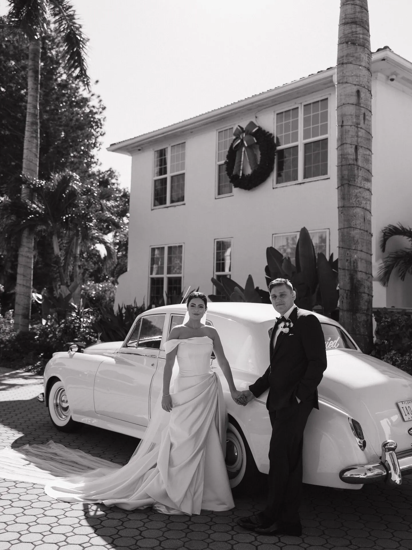 Wedding couple with vintage Rolls-Royce wedding car rental in Naples Florida